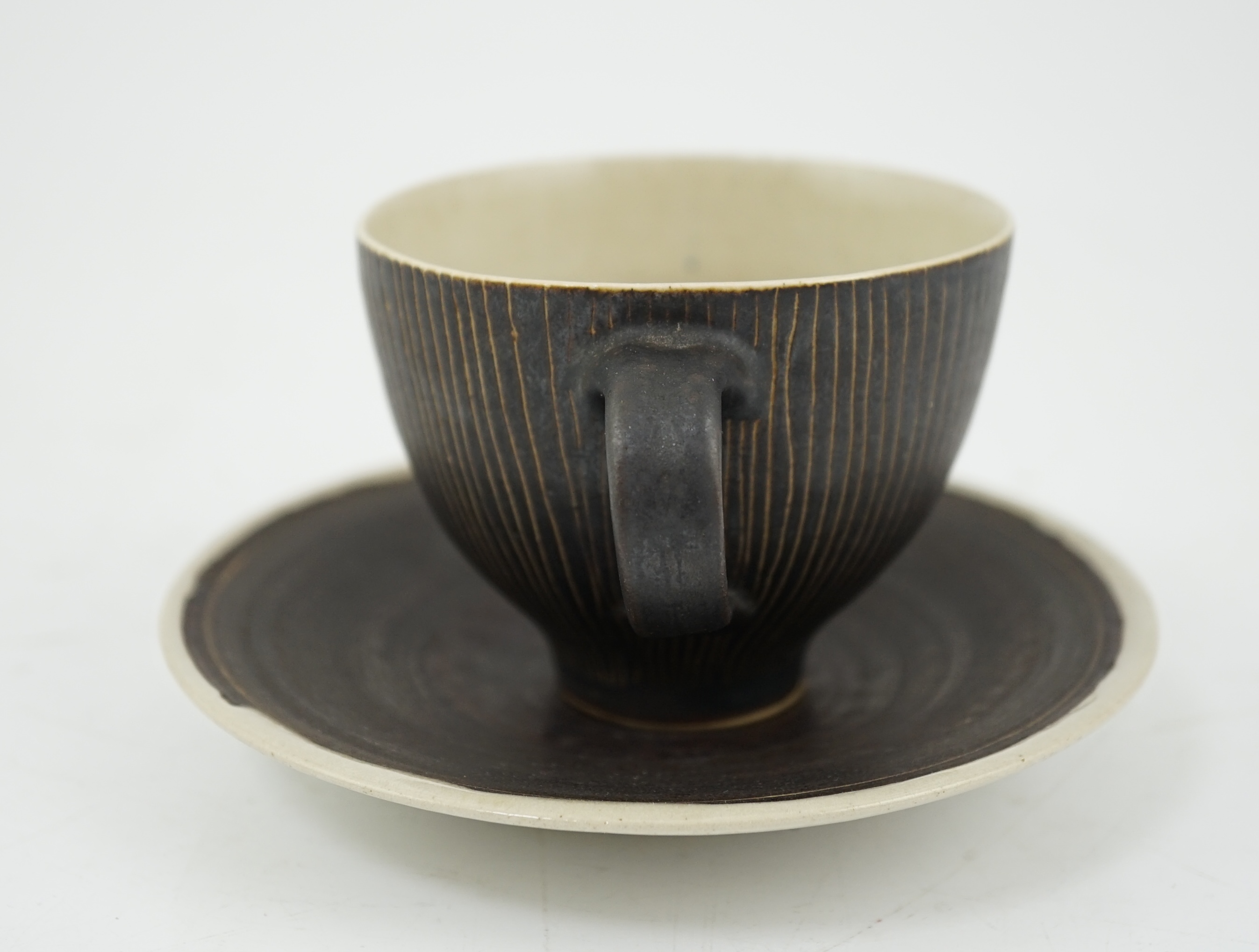 Dame Lucie Rie D.B.E. (1902-1995), a manganese glazed coffee cup and saucer